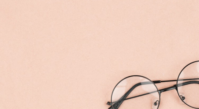 Round hipster sunglasses on pink background. Fashion accessory for women.640×350